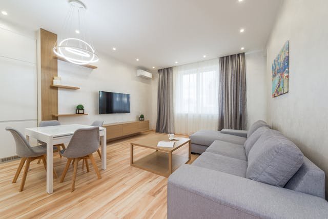 Top 8 Things to Check Before Buying an Apartment in Nairobi 3 apartment-with-sofa-and-table-with-chairs-next-to-tv